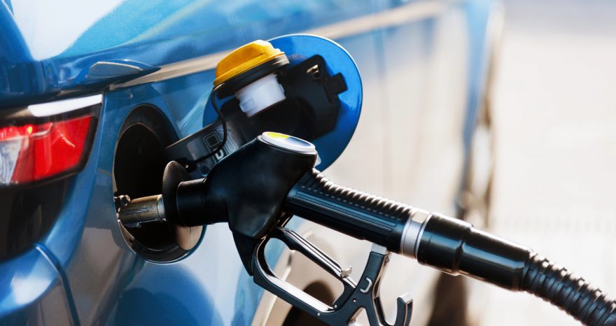 Rinnovabili • Fuel pump nozzle refuelling a vehicle at a petrol station