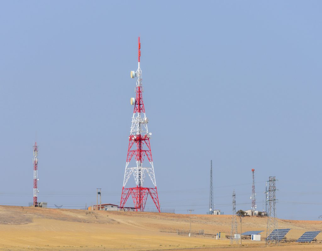 Solar panels beside a telecommunications tower illustrating renewable power solutions